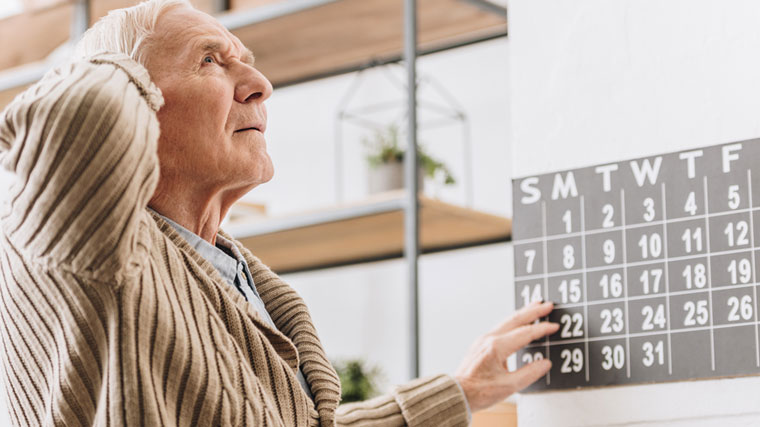 Man with Alzheimer's disease seems confused over the date