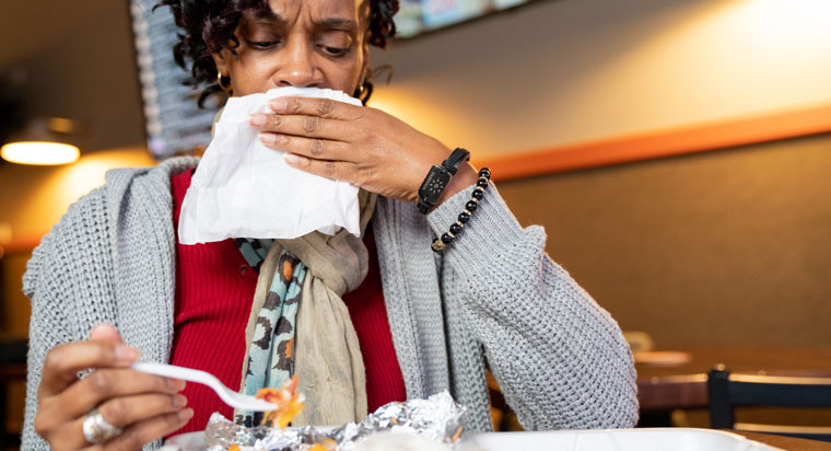 Woman feels gallbladder pain while eating a meal